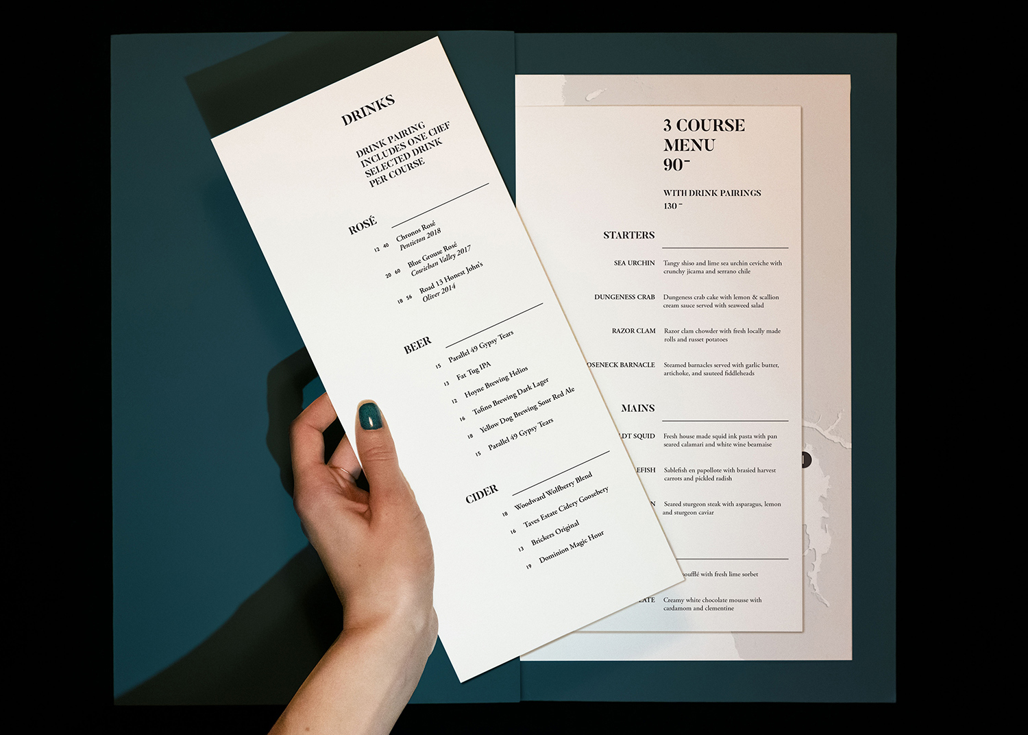 Oystercatcher Restaurant Menu with hand turning page.